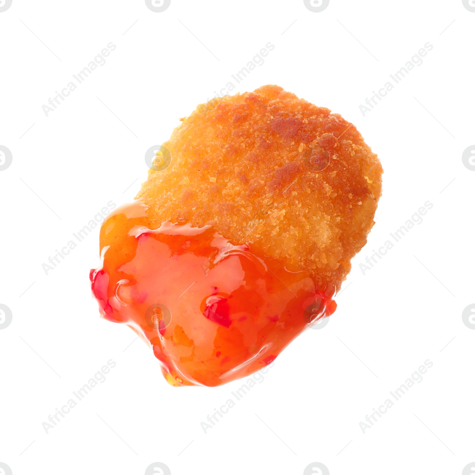 Photo of Tasty nugget dipped in hot chili sauce isolated on white