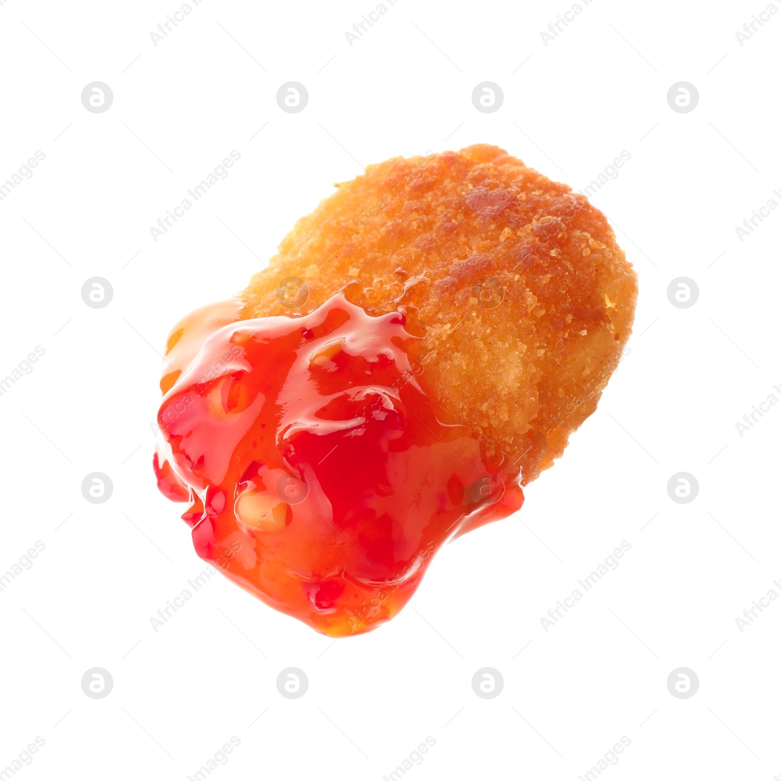 Photo of Tasty nugget dipped in hot chili sauce isolated on white