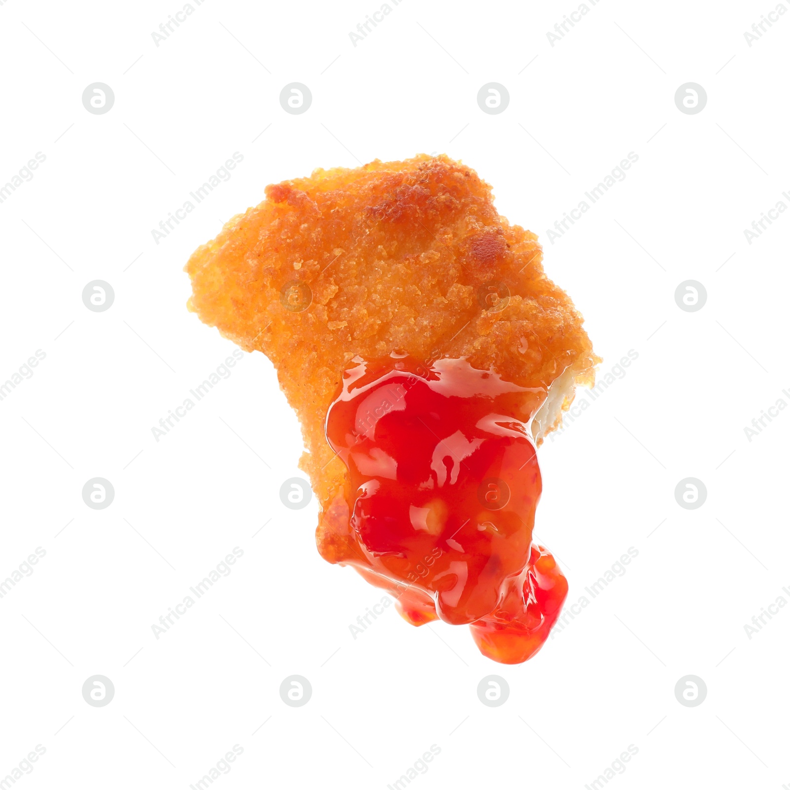 Photo of Tasty nugget dipped in hot chili sauce isolated on white