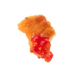 Photo of Tasty nugget dipped in hot chili sauce isolated on white