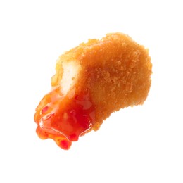 Photo of Tasty nugget dipped in hot chili sauce isolated on white