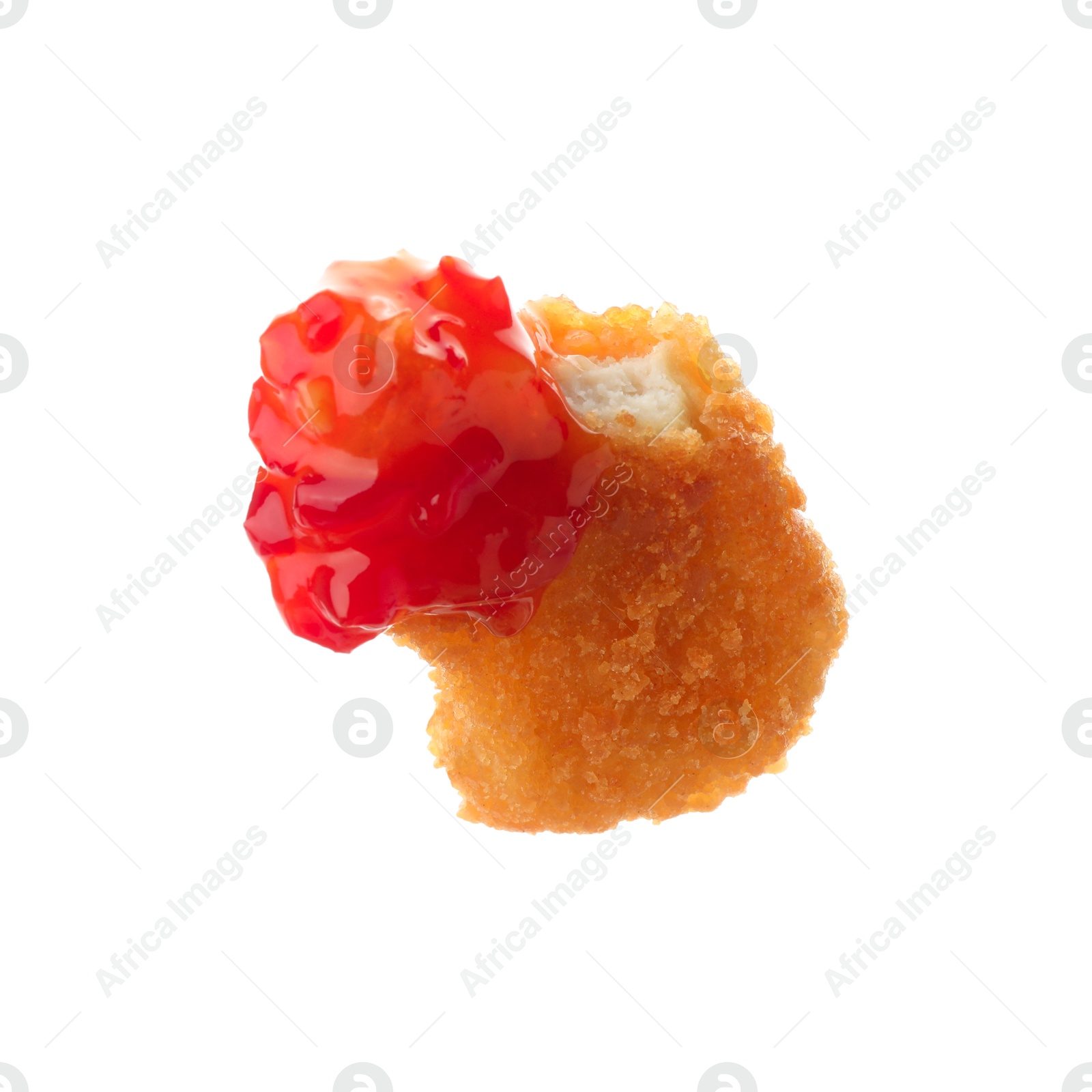 Photo of Tasty nugget dipped in hot chili sauce isolated on white