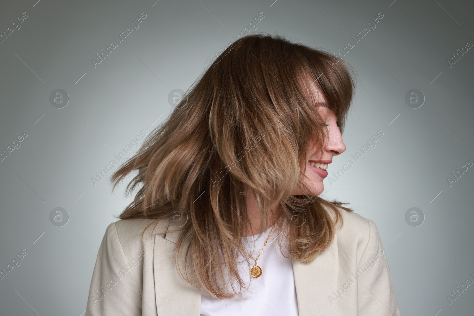 Photo of Attractive woman with stylish haircut on grey gradient background