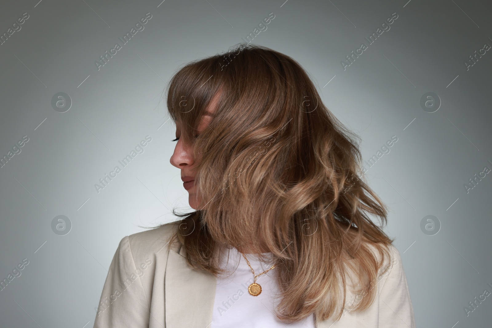 Photo of Attractive woman with stylish haircut on grey gradient background