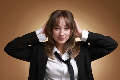 Attractive woman with stylish haircut on brown gradient background