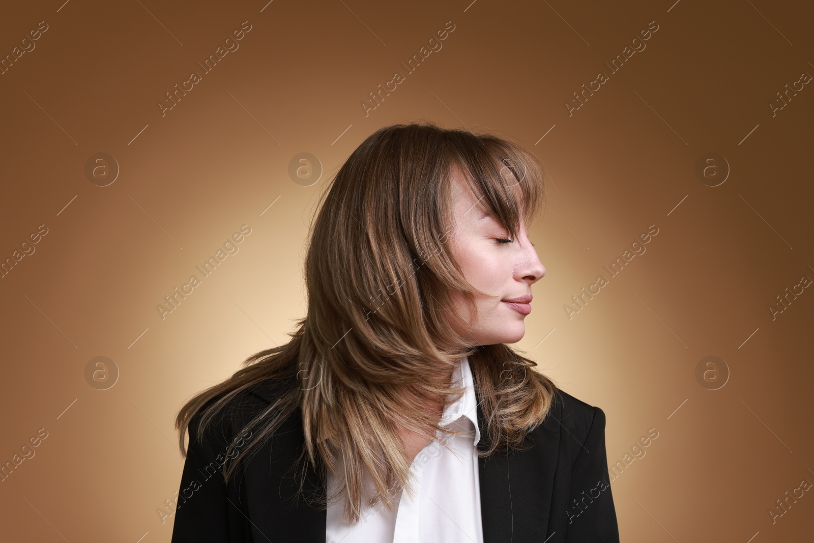 Photo of Attractive woman with stylish haircut on brown gradient background