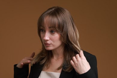 Photo of Attractive woman with stylish haircut on brown background