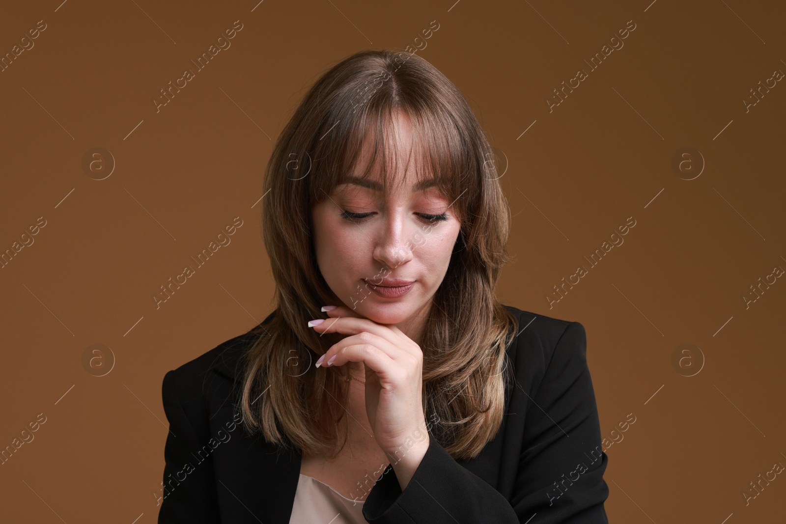 Photo of Attractive woman with stylish haircut on brown background