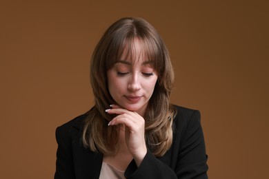 Photo of Attractive woman with stylish haircut on brown background