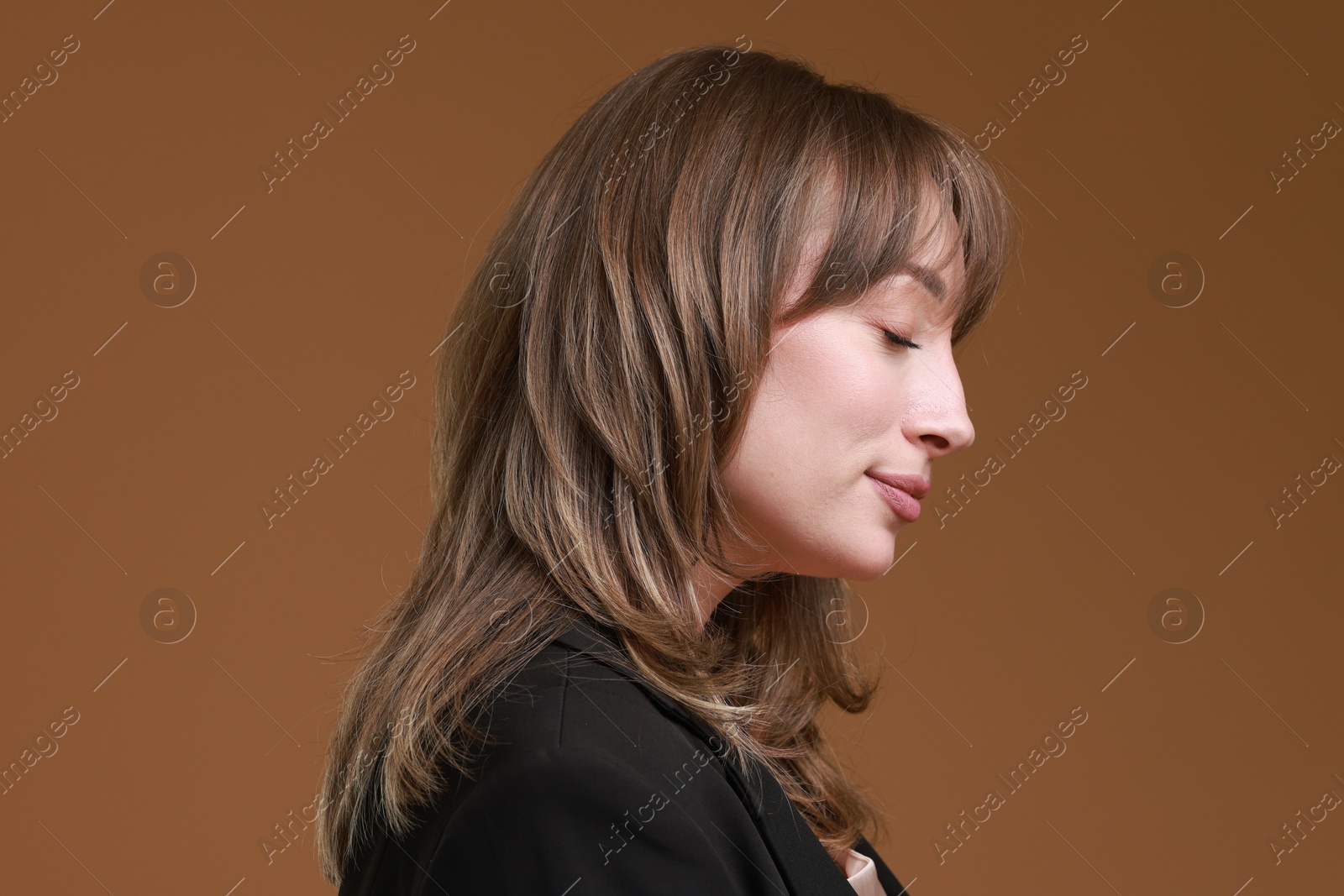 Photo of Attractive woman with stylish haircut on brown background