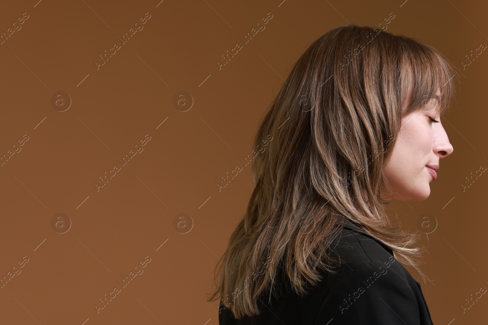 Photo of Attractive woman with stylish haircut on brown background, space for text