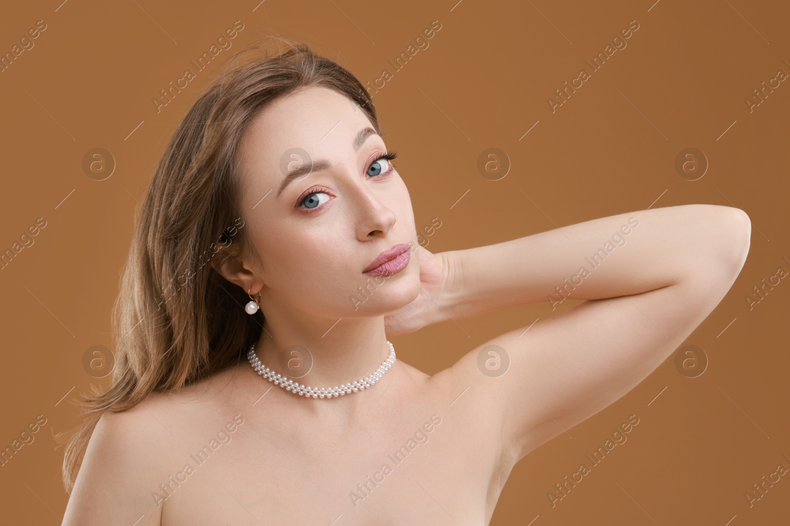 Photo of Attractive woman with stylish haircut on brown background