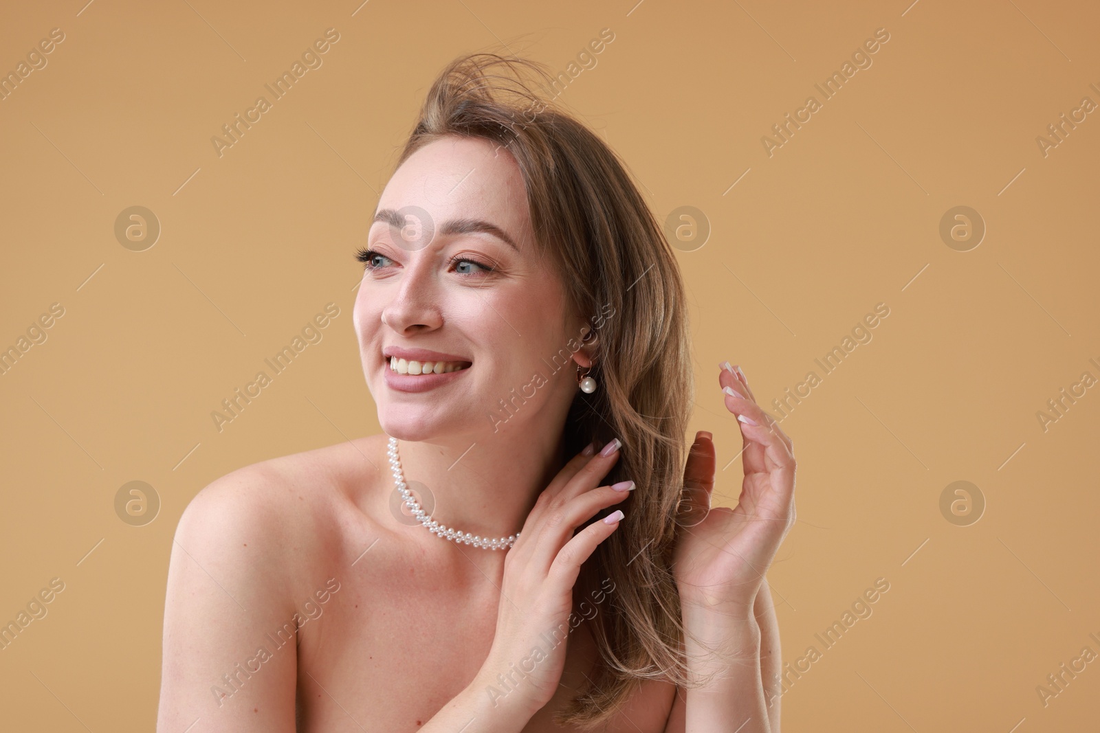 Photo of Attractive woman with stylish haircut on beige background