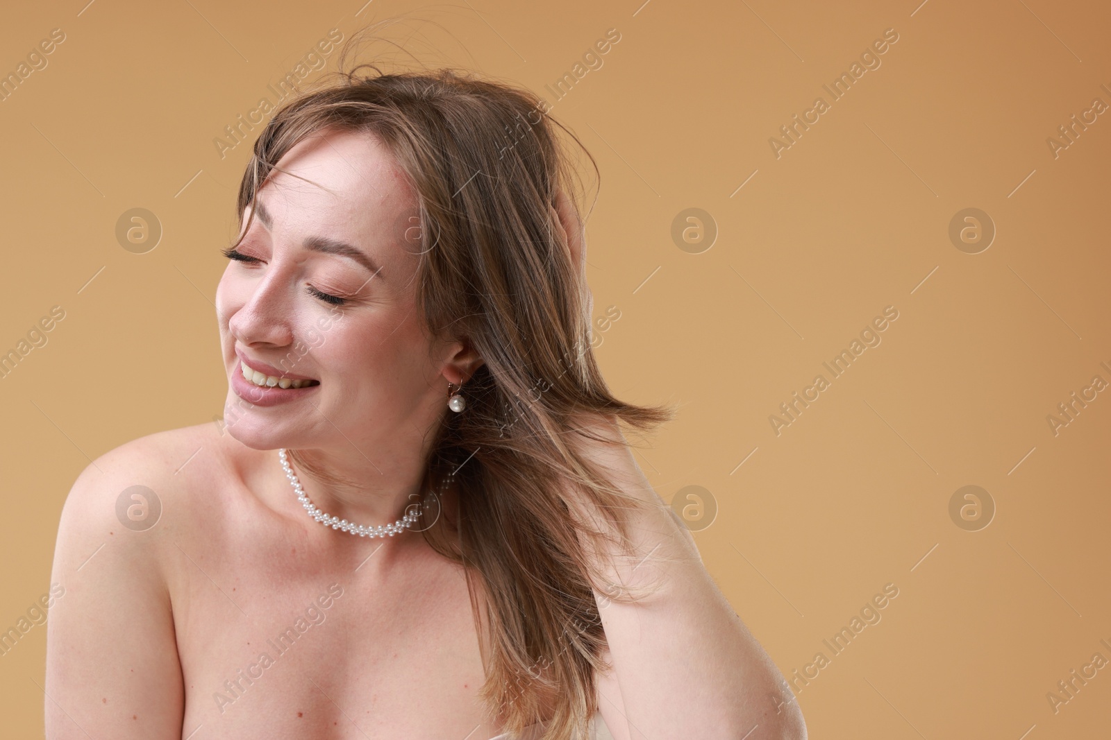 Photo of Attractive woman with stylish haircut on beige background