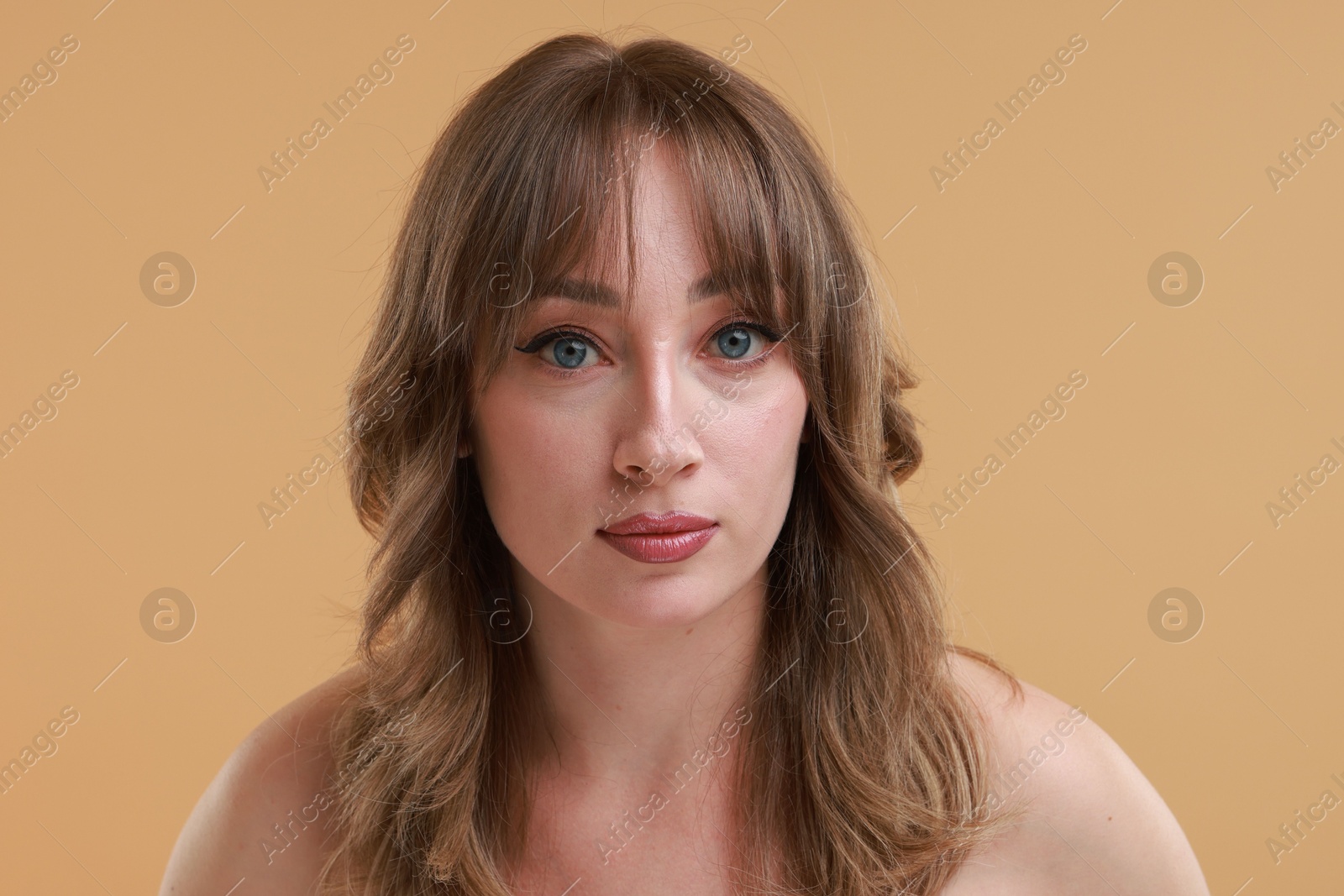 Photo of Attractive woman with stylish haircut on beige background