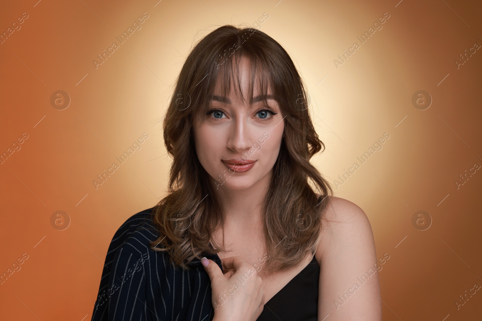 Photo of Attractive woman with stylish haircut on brown gradient background