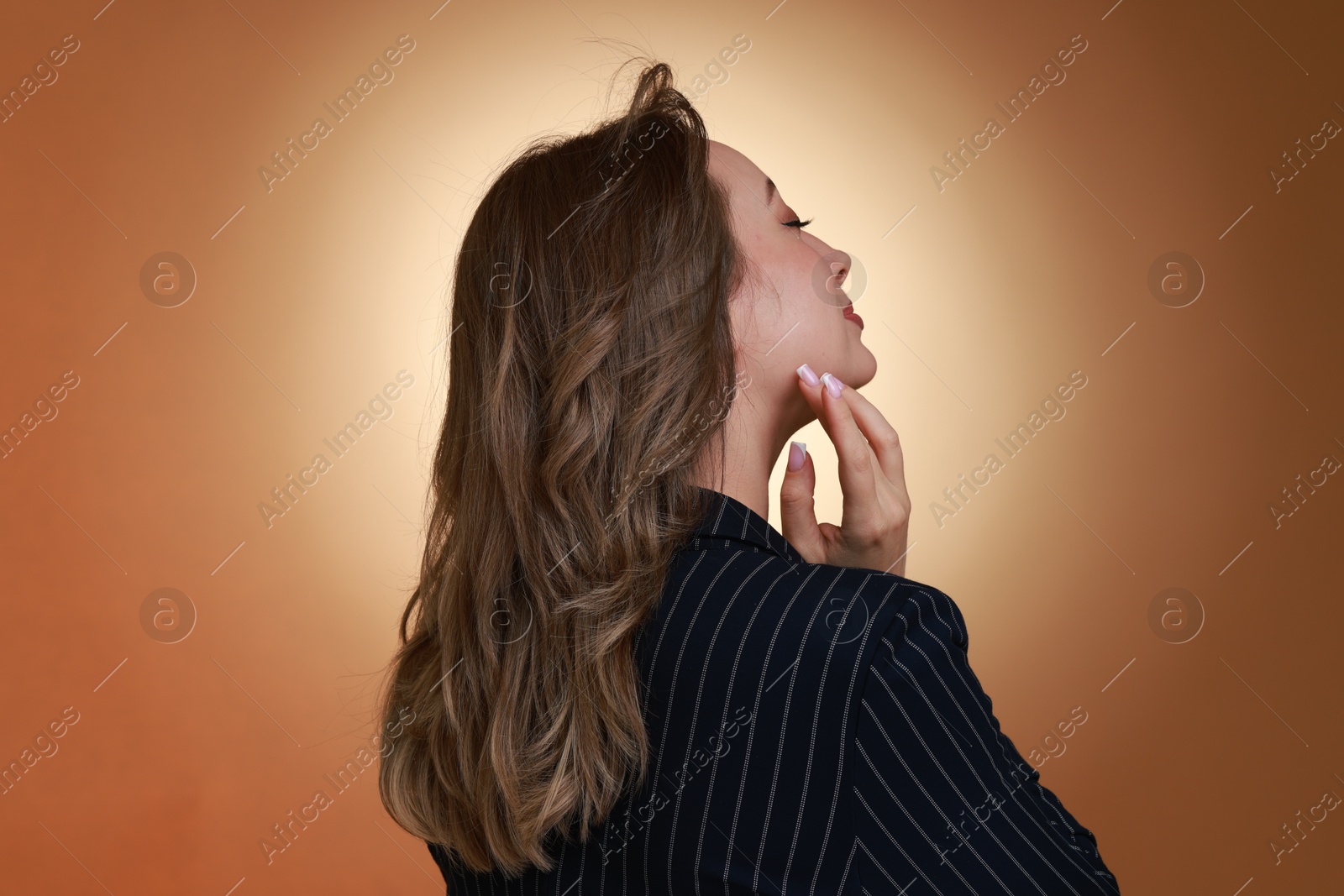 Photo of Attractive woman with stylish haircut on brown gradient background