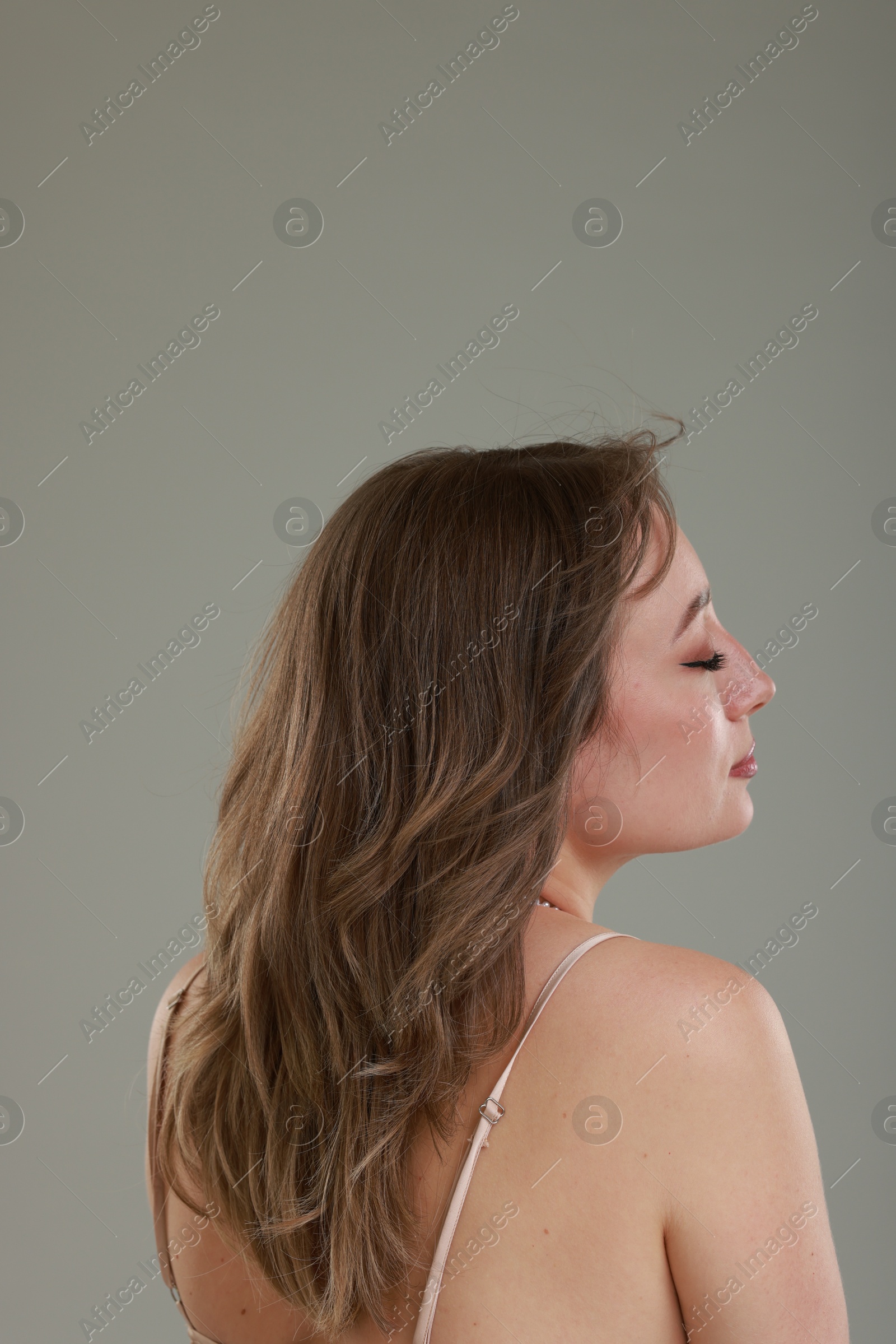 Photo of Attractive woman with stylish haircut on grey background