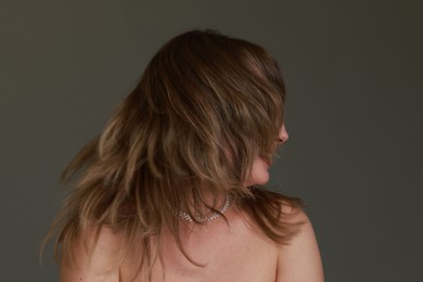 Photo of Woman with stylish haircut on grey background