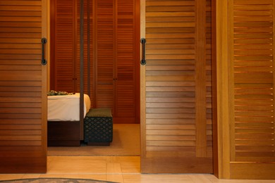 Stylish wooden sliding doors in hotel room