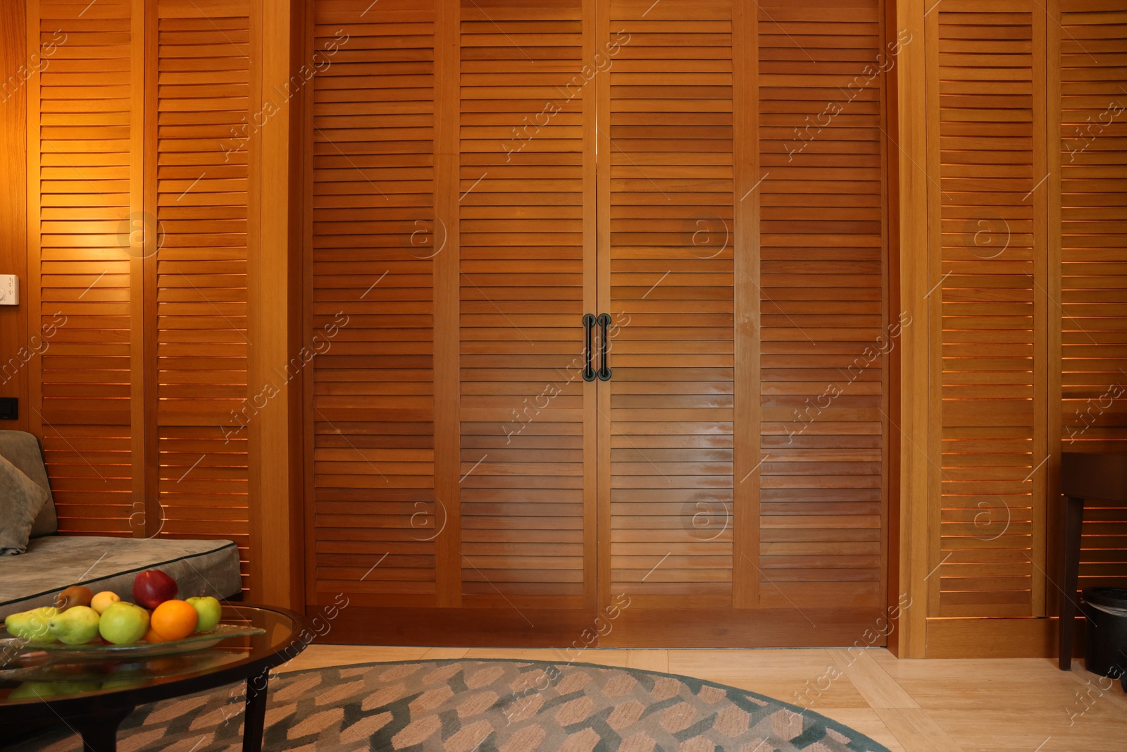 Photo of Stylish wooden sliding doors in hotel room