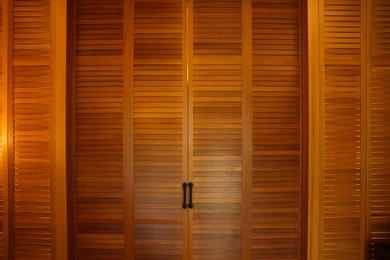 Photo of Stylish wooden sliding doors in hotel room