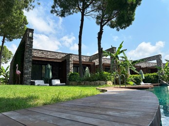 Luxury resort with outdoor swimming pool and green trees