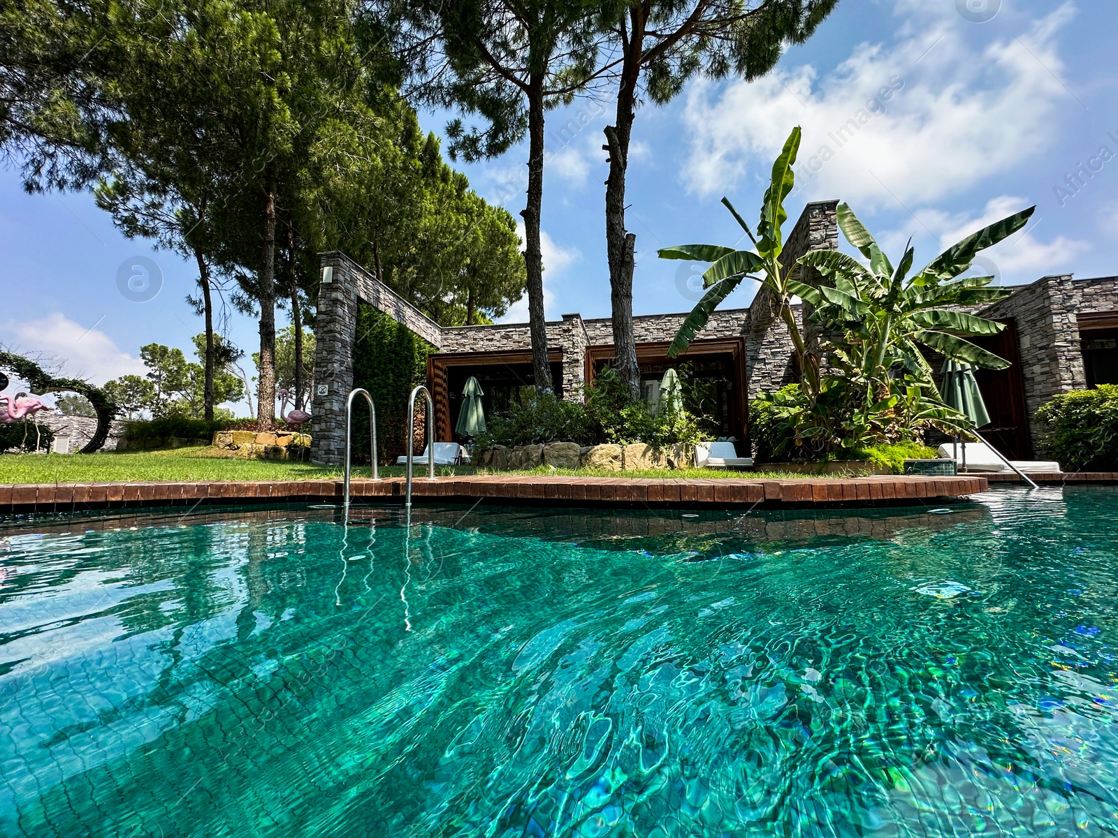 Photo of Outdoor swimming pool with clear water at luxury resort