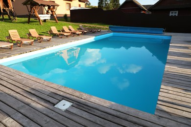 Photo of Outdoor swimming pool and sunbeds in luxury hotel