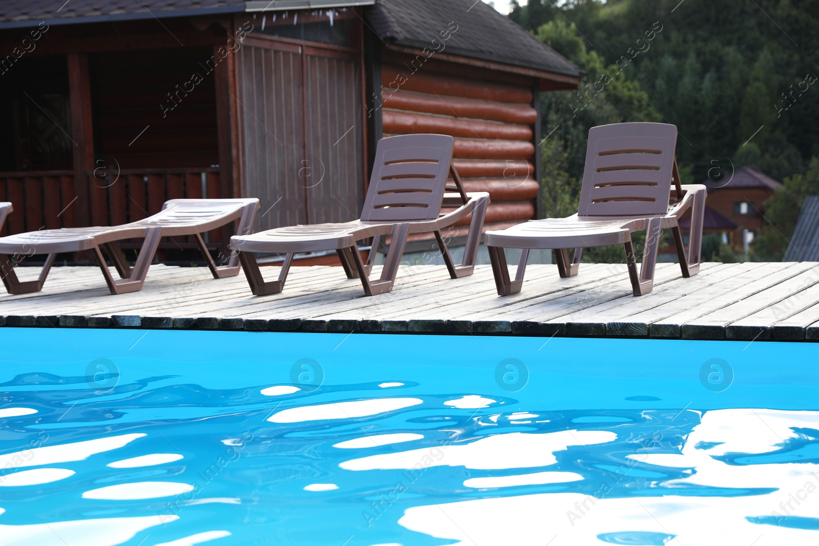 Photo of Outdoor swimming pool and sunbeds in luxury hotel