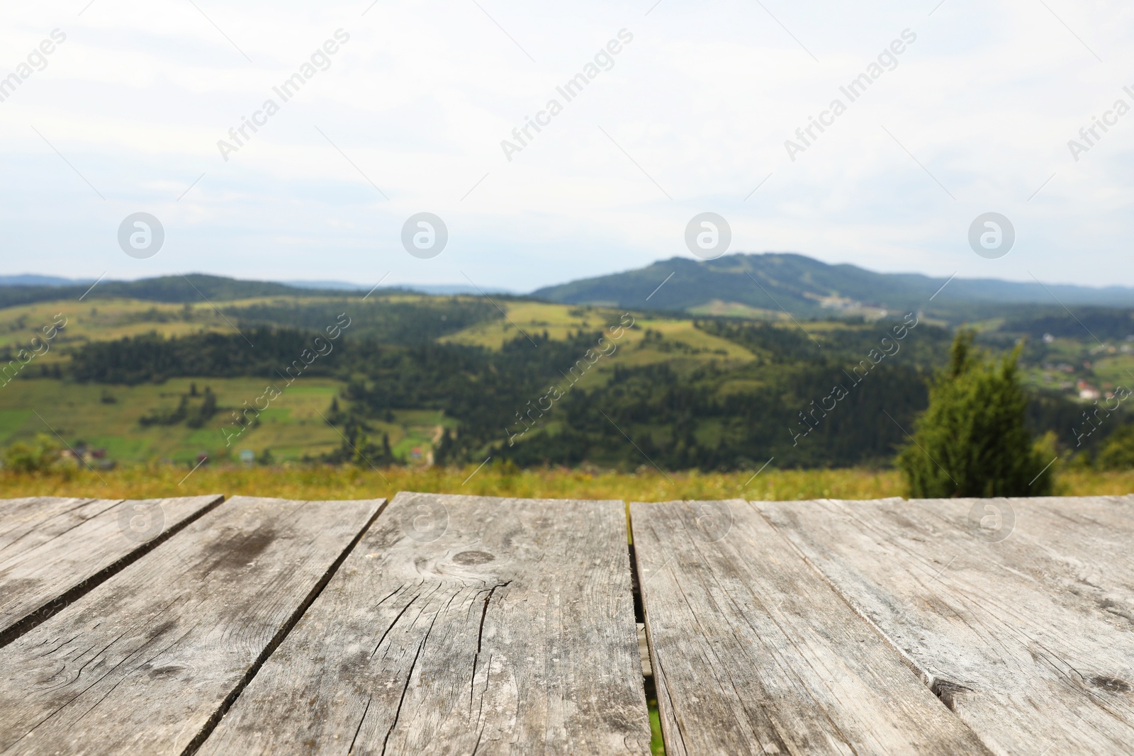 Photo of Empty wooden surface in mountains. Space for text