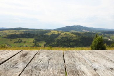 Photo of Empty wooden surface in mountains. Space for text