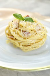 Photo of Plate with delicious pasta Carbonara on table, closeup