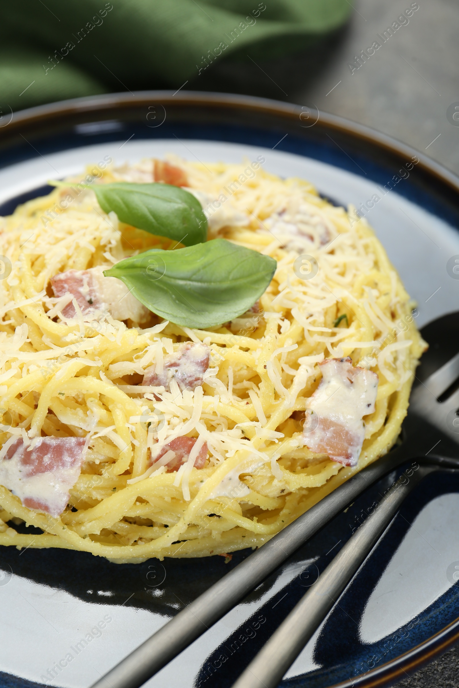 Photo of Plate with delicious pasta Carbonara on table, closeup