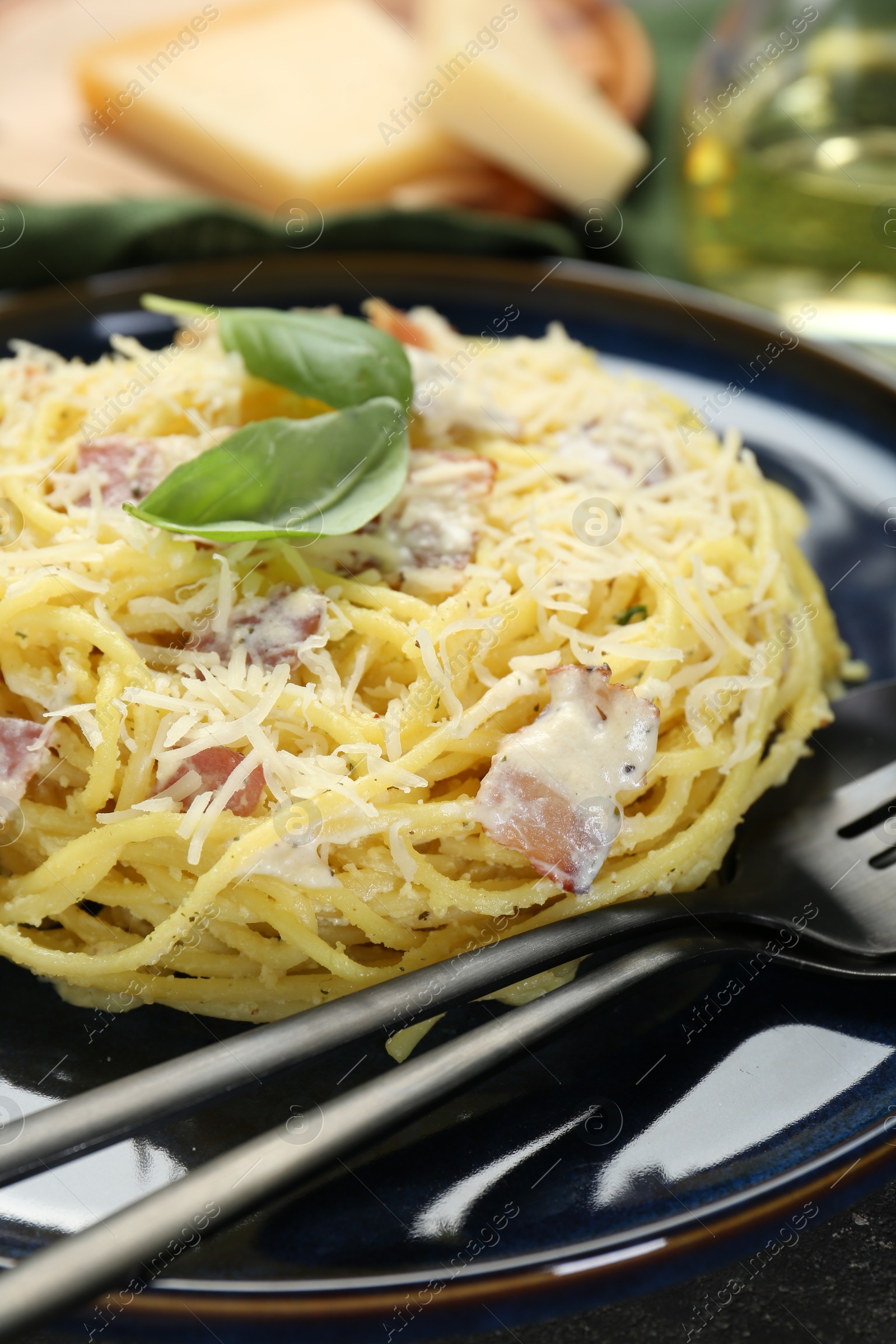 Photo of Plate with delicious pasta Carbonara on table, closeup