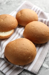 Photo of Many fresh tasty buns on table, closeup