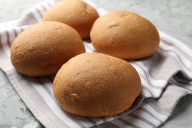 Photo of Many fresh tasty buns on table, closeup