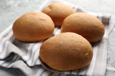 Many fresh tasty buns on table, closeup