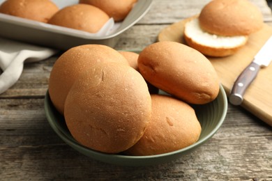 Fresh tasty buns on wooden table, closeup