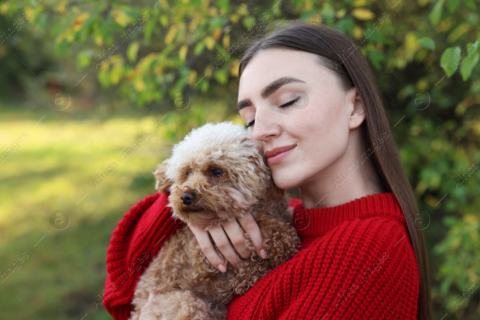 Photo of Woman with cute dog in autumn park