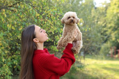 Woman with cute dog in autumn park