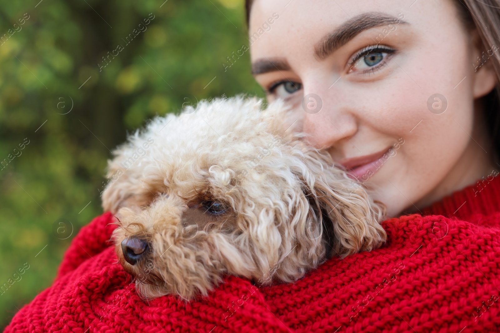 Photo of Portrait of woman with cute dog outdoors, closeup