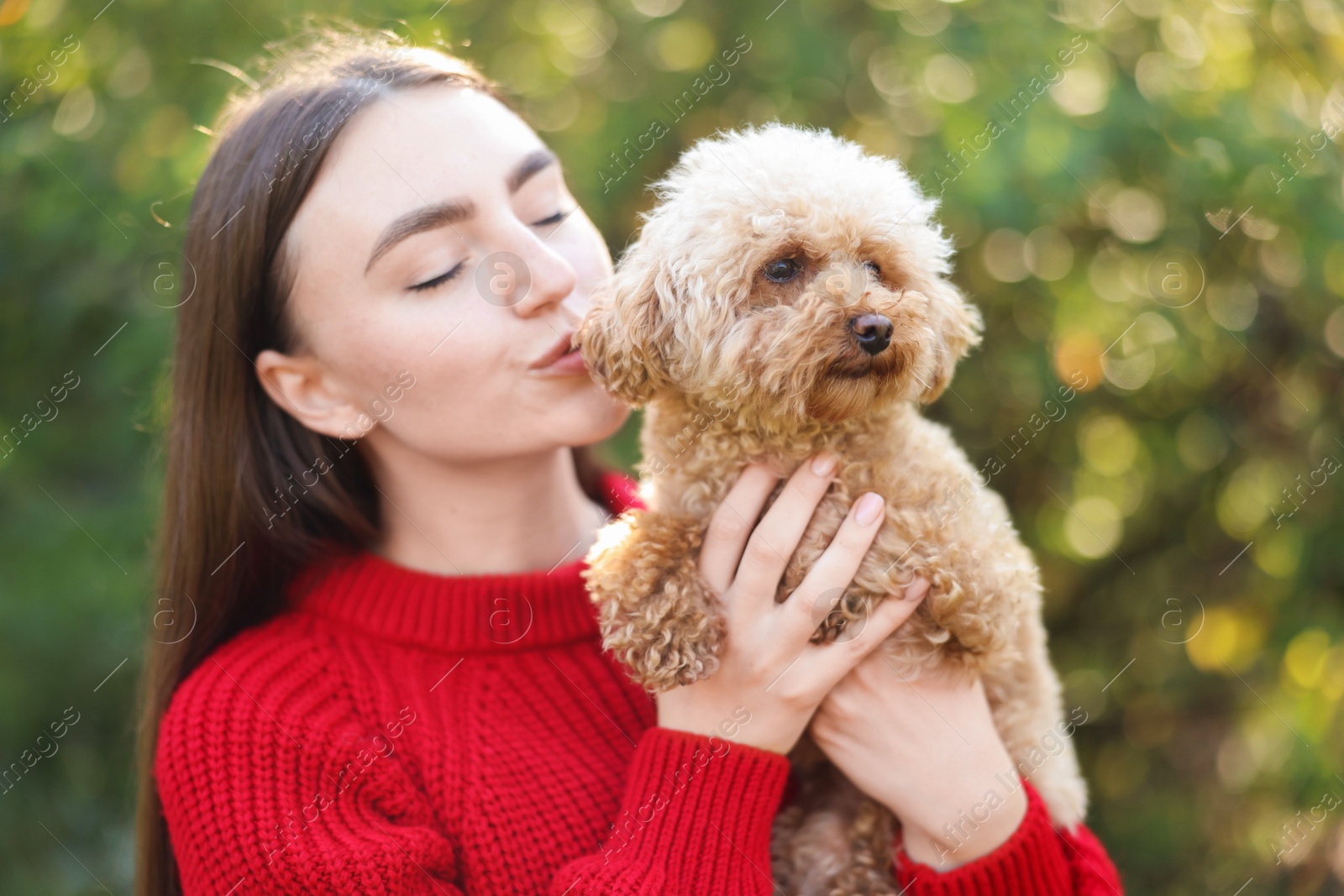 Photo of Portrait of woman with cute dog outdoors