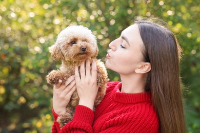 Photo of Portrait of woman with cute dog outdoors