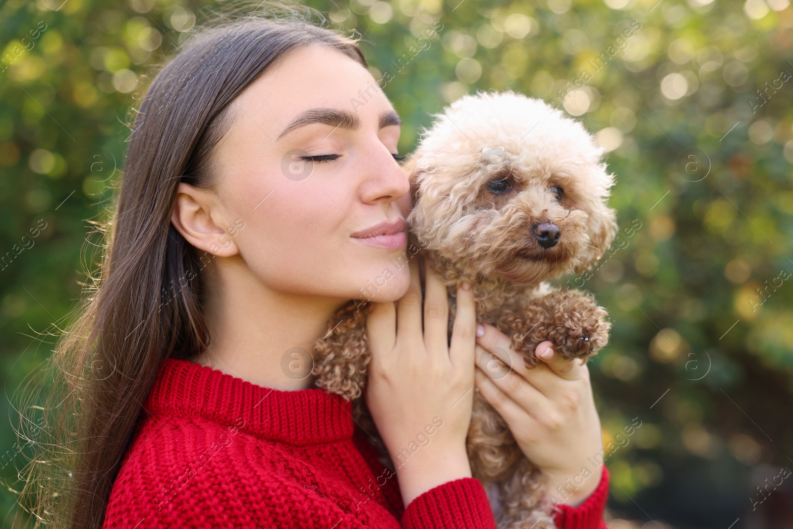 Photo of Portrait of woman with cute dog outdoors