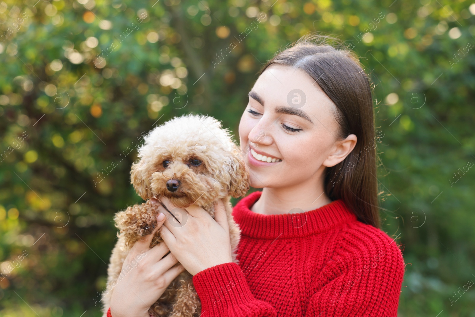 Photo of Portrait of woman with cute dog outdoors