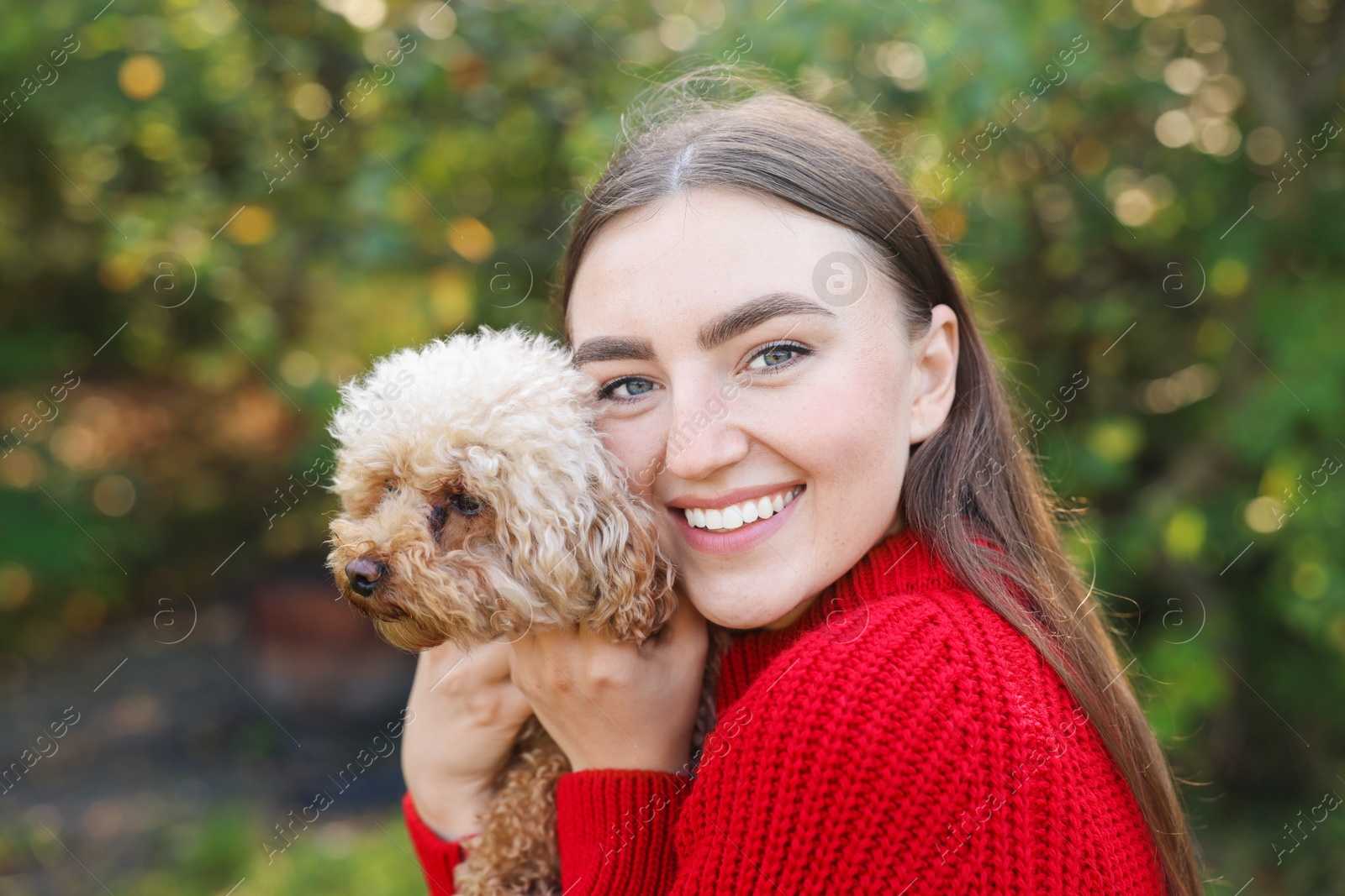 Photo of Portrait of woman with cute dog outdoors