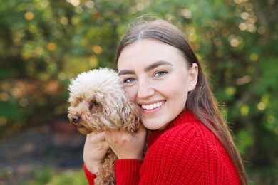 Photo of Portrait of woman with cute dog outdoors