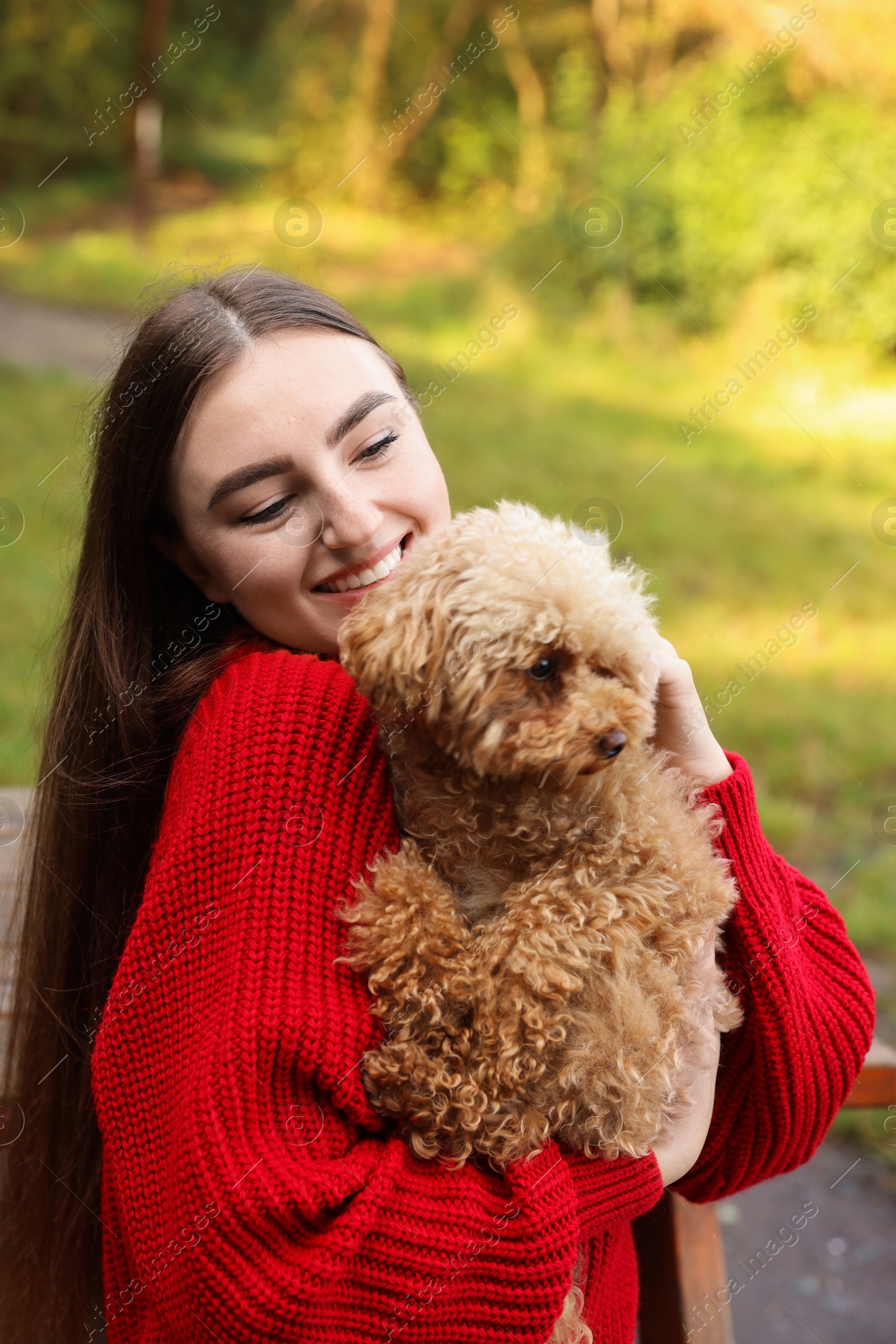 Photo of Smiling woman with cute dog in autumn park