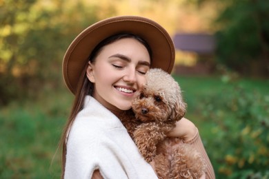 Portrait of smiling woman with cute dog outdoors